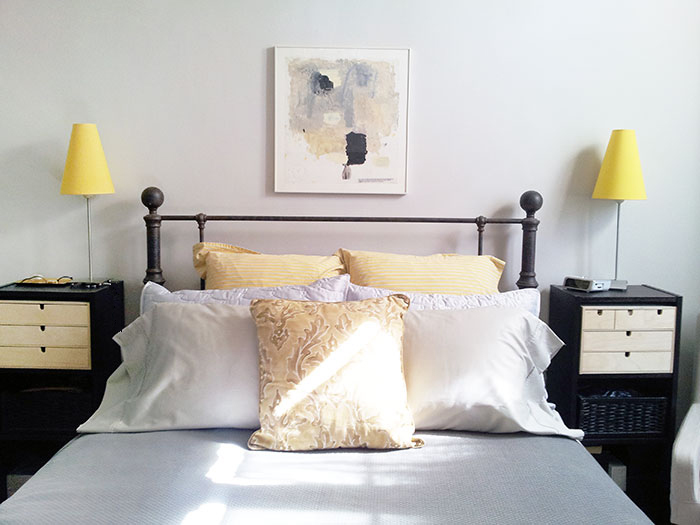 Gray/yellow/black bedroom. Art by Deborah Dancy.
